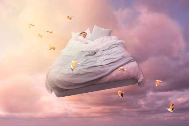 a-sleeping-girl-floats-on-a-bed-in-the-sky-and